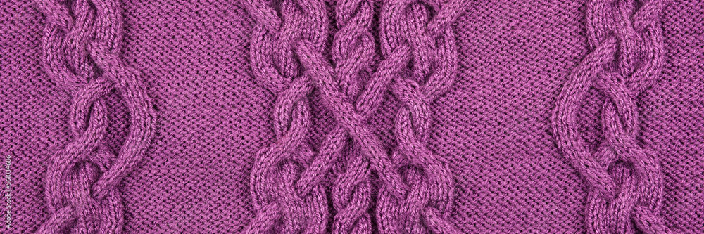 Knitted lilac background. Large knitted fabric with a pattern. Close-up of a knitted blanket. Horizontal ornament. Banner