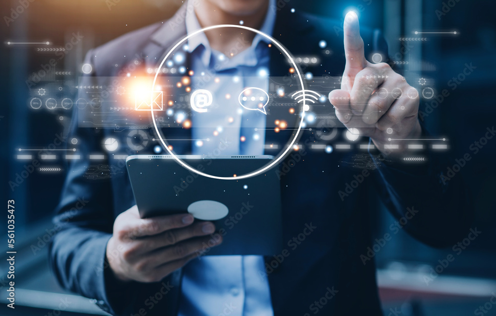 Contact us or Customer support hotline people connect. Businessman using a laptop and touching on virtual screen contact icons ( email, address, live chat, internet wifi ). Contact us or Customer support hotline people connect. Businessman using a laptop and touching on virtual screen contact icons ( email, address, live chat, internet wifi ).