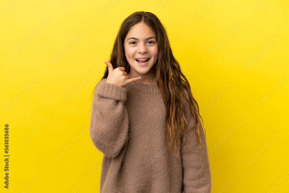 Little caucasian girl isolated on yellow background making phone gesture. Call me back sign Little caucasian girl isolated on yellow background making phone gesture. Call me back sign