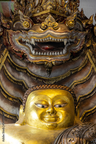 Buddha sitting under the protection of The Naga in a Buddhist temple, Thailand