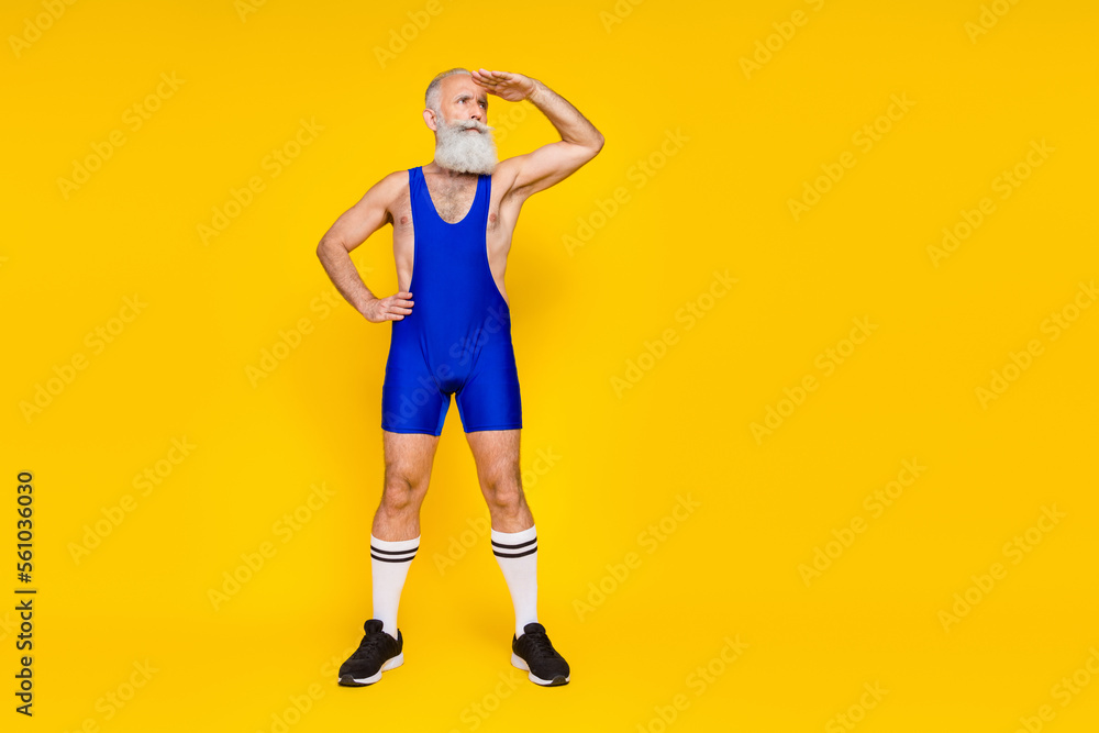 Full body photo of serious focused aged man hand touch forehead look empty space isolated on yellow color background Full body photo of serious focused aged man hand touch forehead look empty space isolated on yellow color background