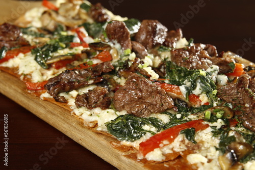 Crispy flatbread with steak, cheese and vegetables