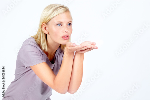 Flirt, thinking and woman with air kiss contemplating, pondering and thoughtful for advertising. Attractive, flirting and affection of isolated model blowing kisses on white background mock up.
