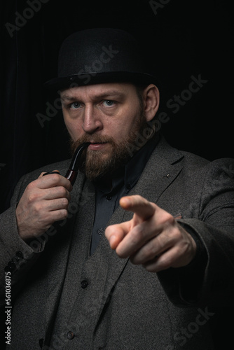 stylish man in retro outfit suit hat smoking wooden pipe sherlock holmes look cosplay england gentleman fashionable confident gangster Guy Ritchie Charlie Hunnam style