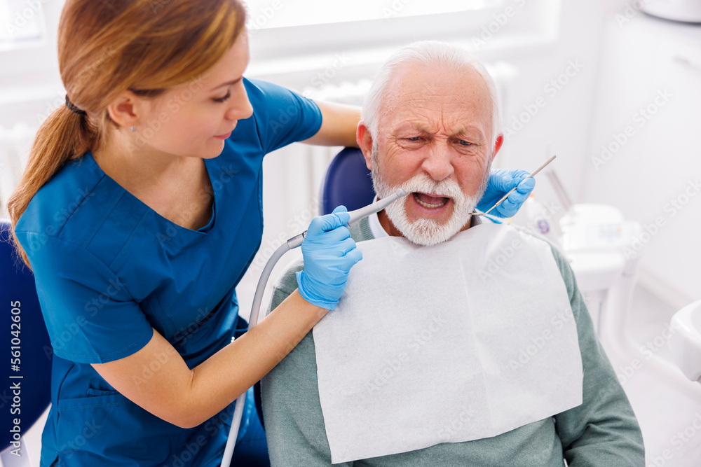 Dentist fixing patients tooth using dental drill Dentist fixing patients tooth using dental drill