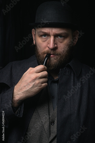 stylish man in retro outfit suit hat smoking wooden pipe sherlock holmes look cosplay england gentleman fashionable confident gangster Guy Ritchie Charlie Hunnam style photo