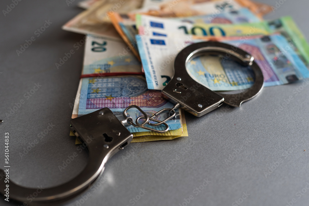 Handcuffs and euro money. Euro banknotes Handcuffs and euro money. Euro banknotes