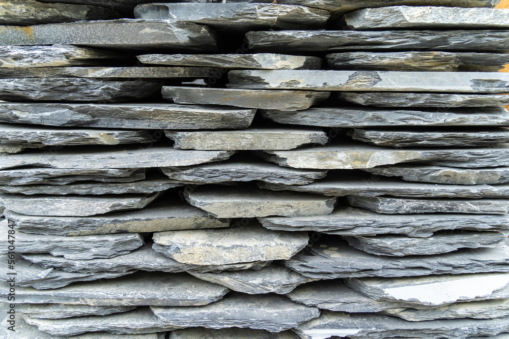 Stack flat slate stones cladding of wall used for flooring, walkways or wall decoration.Background texture