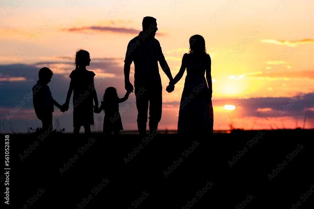 A Happy family silhouette at sea with reflection in park in nature