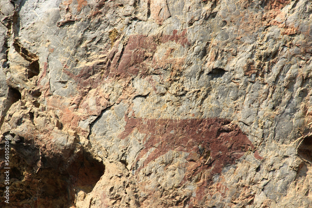 Ancient stone walls, brown and very old, with painted patterns on the surface. Ancient stone walls, brown and very old, with painted patterns on the surface.