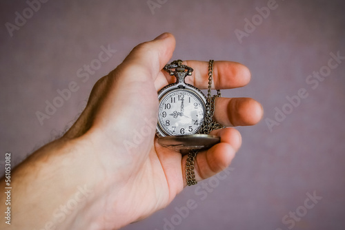 a pocket watch in the hands of a man