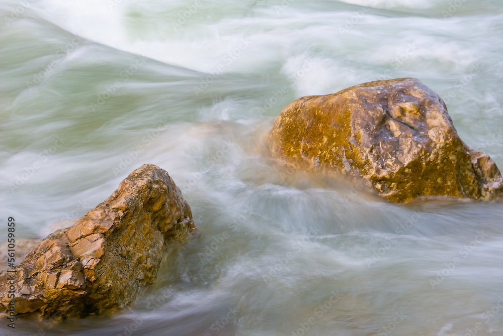 closeup stones among emerald rushing mountain river closeup stones among emerald rushing mountain river
