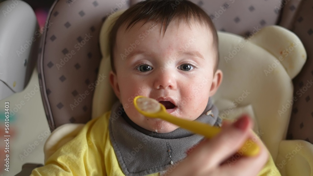 Healthy food. Cute baby girl face. beautiful a baby eats dirty. Healthy food family concept. mother feeds her daughter baby with a spoon, the child is dirty. newborn baby lifestyle breakfast Healthy food. Cute baby girl face. beautiful a baby eats dirty. Healthy food family concept. mother feeds her daughter baby with a spoon, the child is dirty. newborn baby lifestyle breakfast
