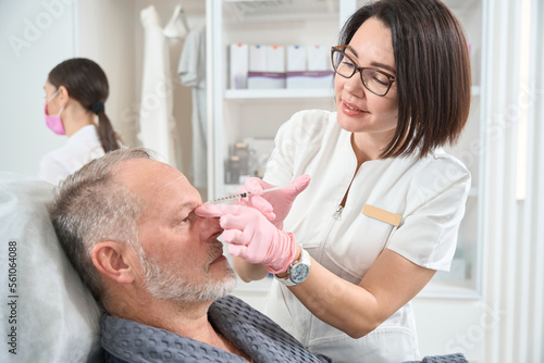 Elderly man undergoes rejuvenating course with the use of fillers