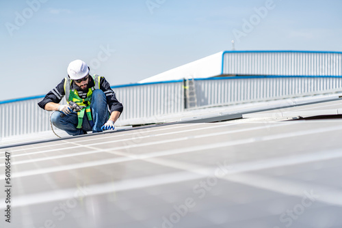 Male engineer installing or checking the working condition of solar panels on the roof or at the height of the factory for saving electricity was broken to use renewable energy from the sun