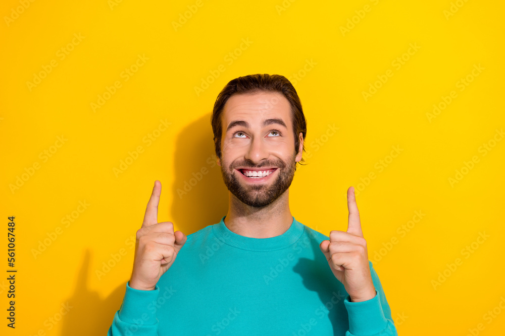 Photo of handsome attractive toothy beaming smile guy look direct fingers up new whitening medicine clinic promo isolated on yellow color background Photo of handsome attractive toothy beaming smile guy look direct fingers up new whitening medicine clinic promo isolated on yellow color background
