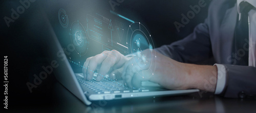 Hands typing on keyboard and virtual infographic data