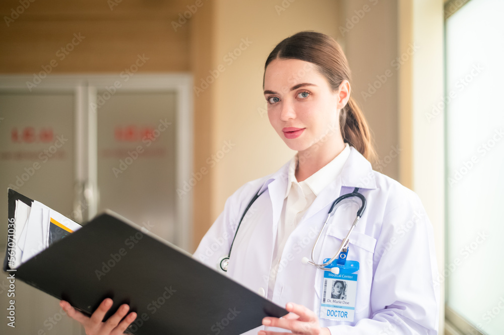 Woman doctor holding folder in hospital background medicine, profession and healthcare concept - happy smiling female doctor in white coat with folder and stethoscope over hospital background Woman doctor holding folder in hospital background medicine, profession and healthcare concept - happy smiling female doctor in white coat with folder and stethoscope over hospital background