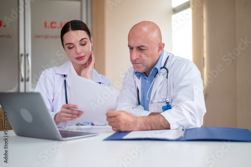 doctor talking with woman doctor at hospital meeting room