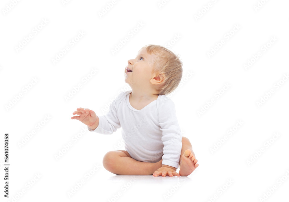Little, happy and smiling cute baby in the studio. Portrait of a one year old baby. The concept of happiness. Little, happy and smiling cute baby in the studio. Portrait of a one year old baby. The concept of happiness.