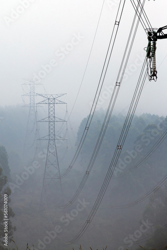 Towers of eletric power transmission in fog photo