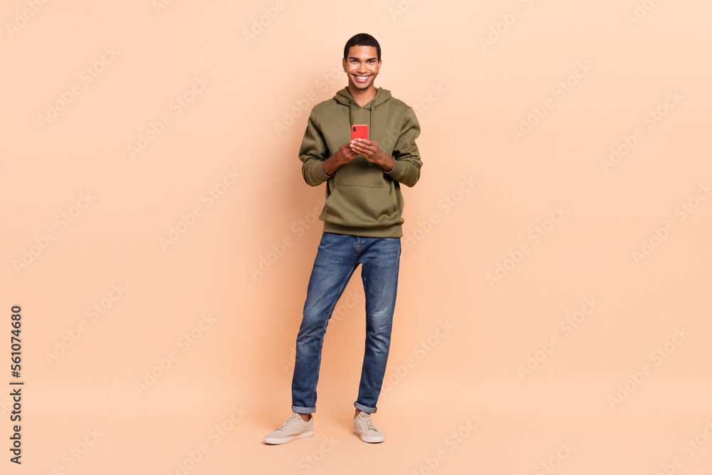 Photo of nice cheerful man blogger use modern telephone sumsung iphone telegram instagrm app isolated on beige color background Photo of nice cheerful man blogger use modern telephone sumsung iphone telegram instagrm app isolated on beige color background