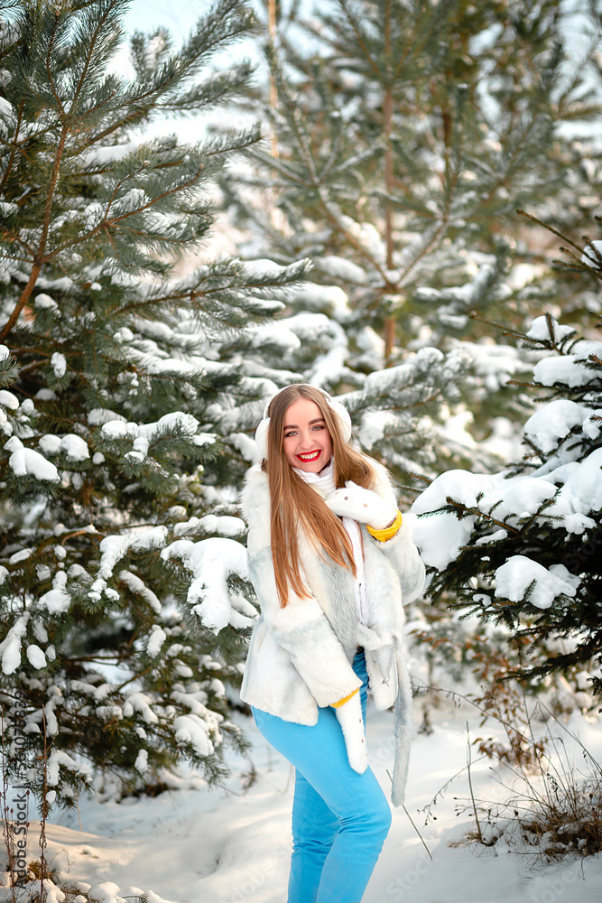 Vinnytsia, Ukraine. January 12, 2023: Portrait of a girl in winter in a white rabbit fur coat. White warm headphones. Sincere smile. Emotions Vinnytsia, Ukraine. January 12, 2023: Portrait of a girl in winter in a white rabbit fur coat. White warm headphones. Sincere smile. Emotions