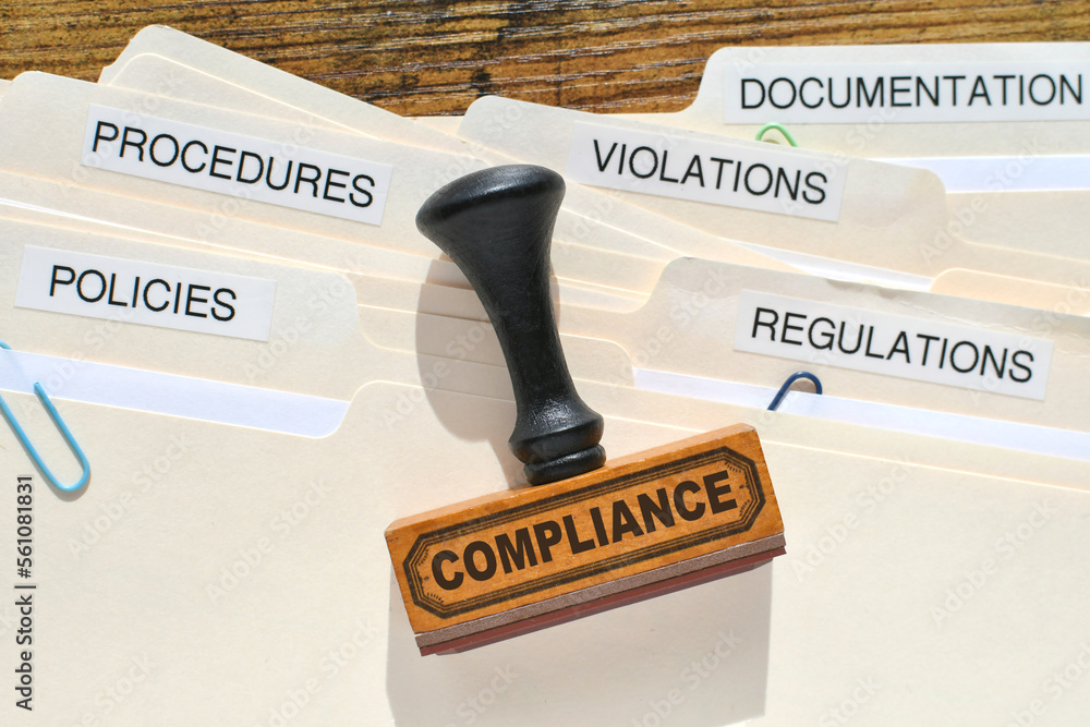 A Compliance rubber stamp on file folders marked Policies Regulations Violations Procedures and Documentation. Compliance in the workplace. - obrazy, fototapety, plakaty 