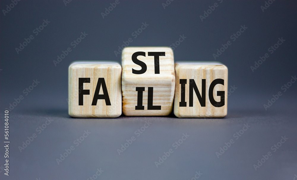 Fasting or failing symbol. Concept word Fasting Failing on wooden cubes. Beautiful grey table grey background. Business, healthy lifestyle and fasting or failing concept. Copy space. Fasting or failing symbol. Concept word Fasting Failing on wooden cubes. Beautiful grey table grey background. Business, healthy lifestyle and fasting or failing concept. Copy space.
