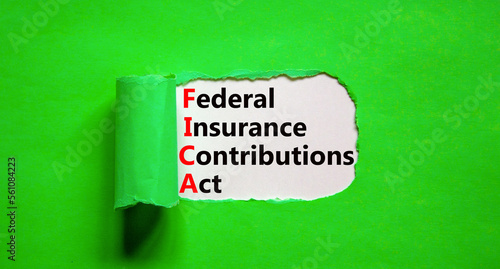 FICA symbol. Concept words FICA federal insurance contributions act on white paper on beautiful green background. Business FICA federal insurance contributions act concept. Copy space.