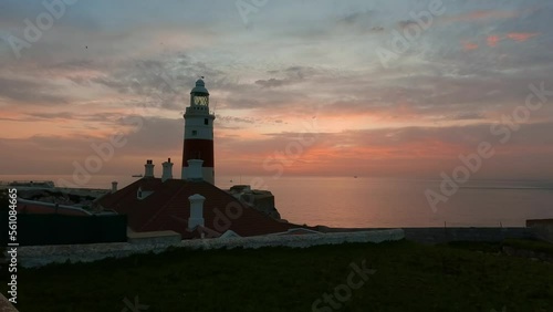 Europa Point Lighthouse with sea in background. Colorful Cloudy Sunrise Sky. Gibraltar, United Kingdom. 4k cinematic