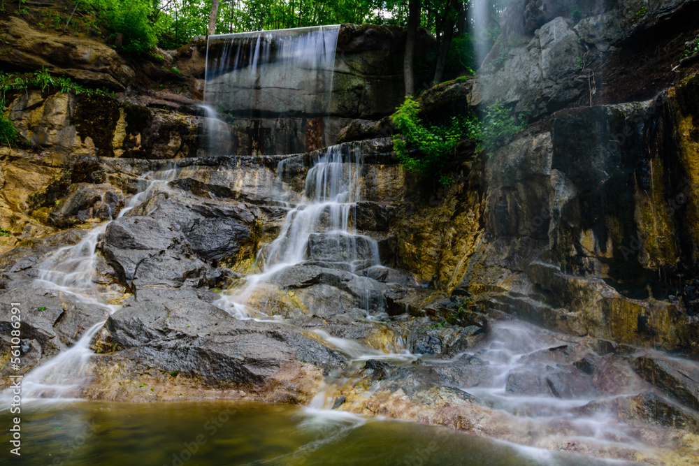 Obraz premium Beautiful waterfall on small river in a park