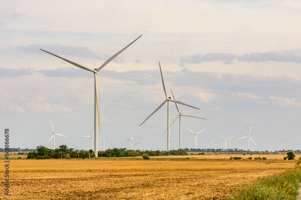Wind turbines at the agricultural field. Clean energy. Ecological concept Wind turbines at the agricultural field. Clean energy. Ecological concept