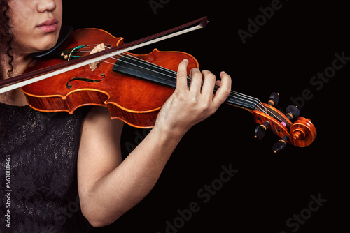 Woman with violin in dark room. Copyspace.