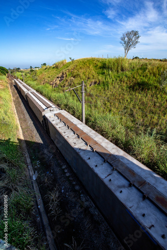 Freight train with numerous wagons between hills on Minas Geraes, Brazil photo