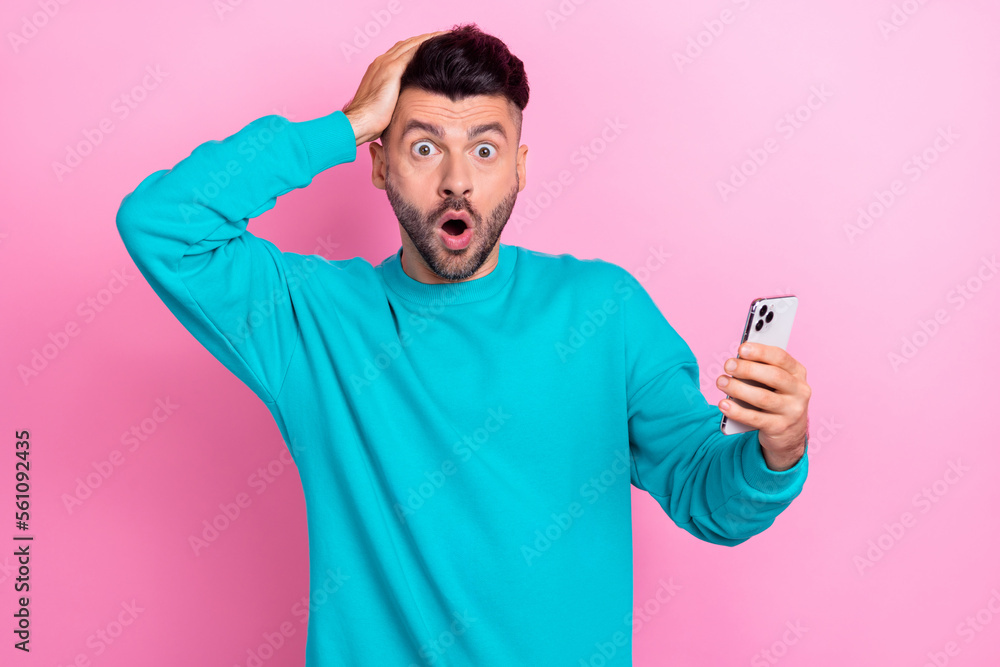 Photo of impressed man hand touch head open mouth staring use telephone isolated on pink color background Photo of impressed man hand touch head open mouth staring use telephone isolated on pink color background