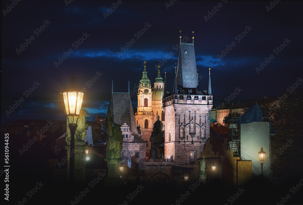 Charles Bridge at night with Lesser Town Bridge Tower and St. Nicholas Church - Prague, Czech Republic