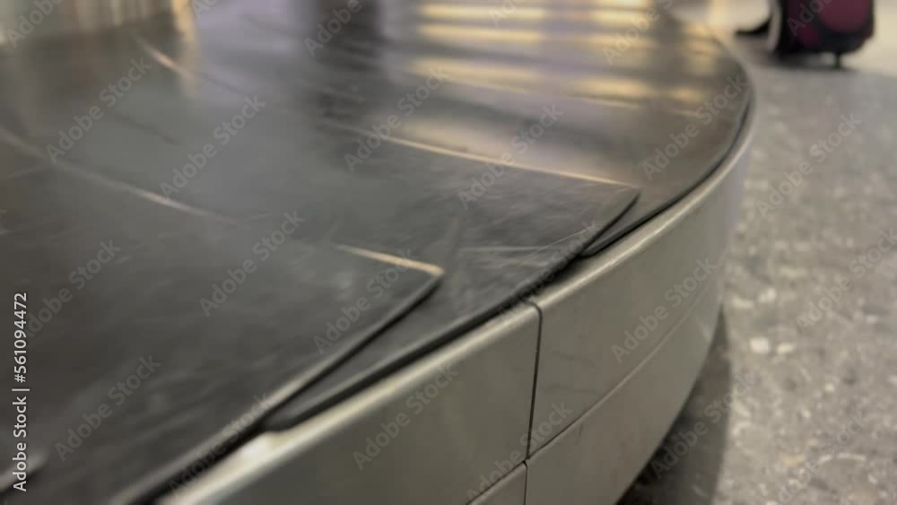 Empty baggage claim airport luggage belt in motion Empty baggage claim airport luggage belt in motion