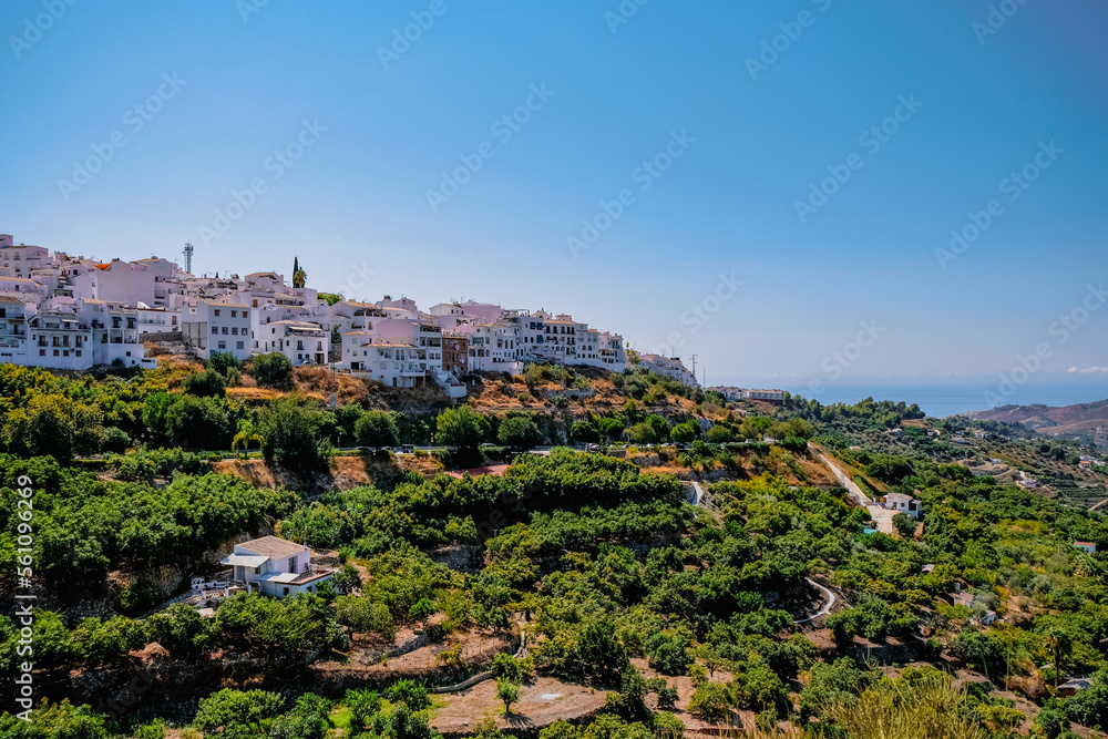 Spanish village on a hill with many white buildigs 