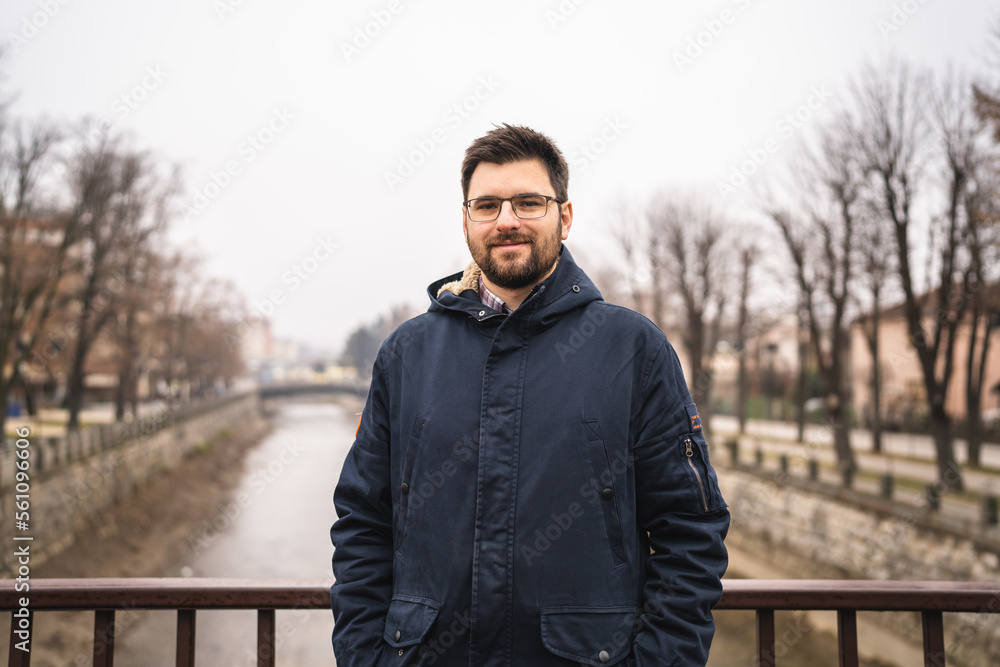 One man with beard and eyeglasses stand outdoor alone in winter day One man with beard and eyeglasses stand outdoor alone in winter day