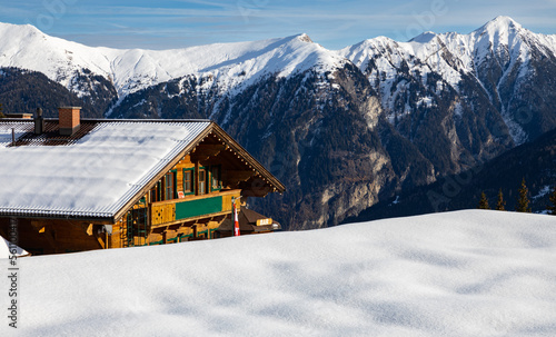 A small hut stands on a high point in the mountains, Austrian Alps