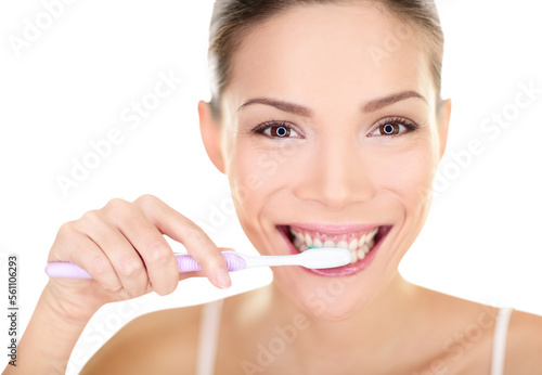 Woman brushing teeth holding toothbrush. Dental care close up portrait of beautiful girl brushing teeth smiling happy looking at camera isolated in transparent PNG. Mixed race Asian Chinese Caucasian.
