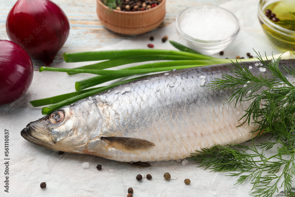 Delicious salted herring and ingredients on wooden table, closeup Delicious salted herring and ingredients on wooden table, closeup