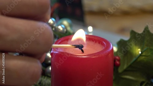 Lighting a candle on the feast day