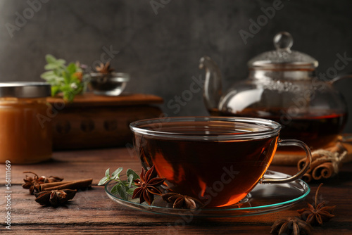 Aromatic tea with anise stars and mint on wooden table. Space for text