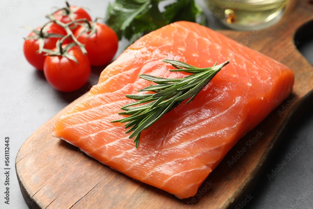 Fresh raw salmon and ingredients for marinade on grey table, closeup Fresh raw salmon and ingredients for marinade on grey table, closeup