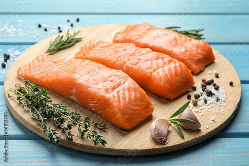 Fresh raw salmon and ingredients for marinade on light blue wooden table, closeup