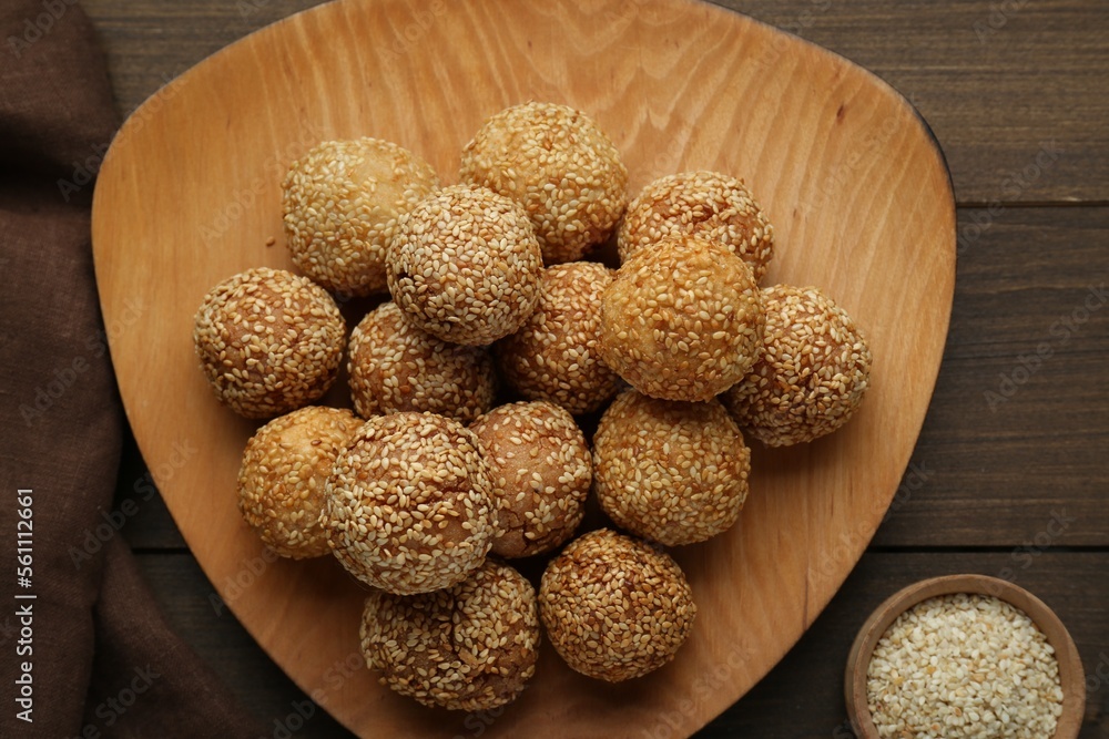 Delicious sesame balls on wooden table, flat lay Delicious sesame balls on wooden table, flat lay