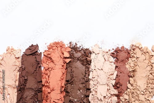 Foto Crushed eye shadows on white background, top view