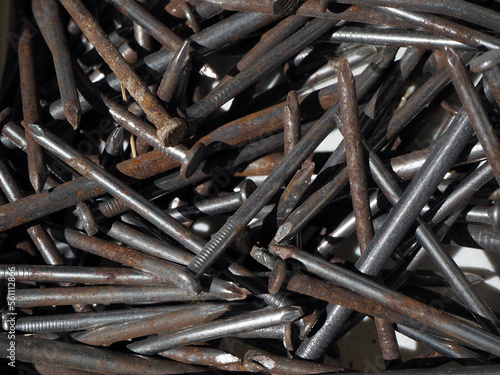 Rusty nails background. Nail pile patterns. Mixed rusty iron nails. photo